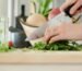 person cutting vegetables with knife